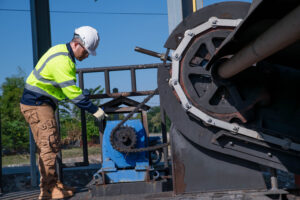 A wastewater treatment plant engineer is inspecting the wastewater treatment plant's sump pump for damage.